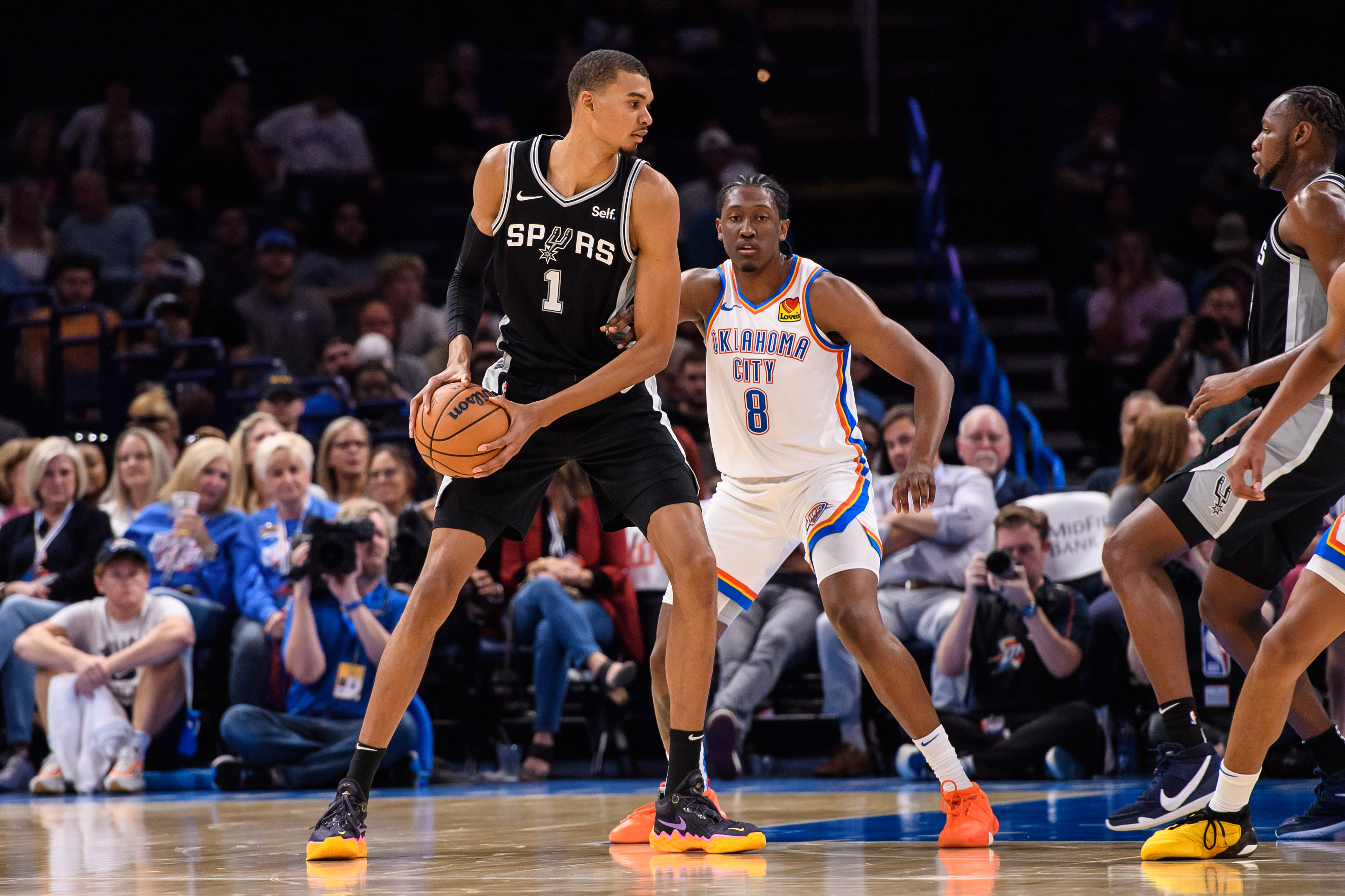 San Antonio Spurs center Victor Wembanyama (1) with the ball while defended by Oklahoma City Thunder forward Jalen Williams (8) during the first half at Paycom Center.